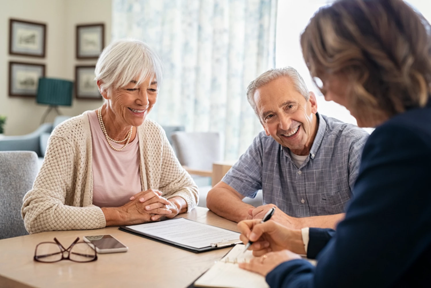 Elderly couple consulting with a home care service provider about private care in home care services.