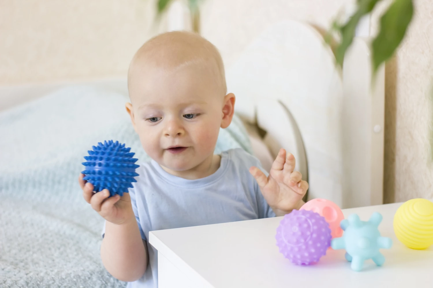 Baby playing with sensory ball as autism therapy