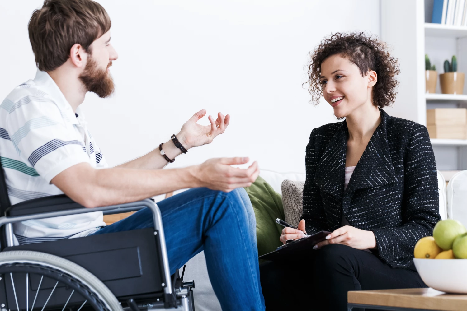 Man in wheelchair discussing his NDIS plan with his Focus Care NDIS Provider