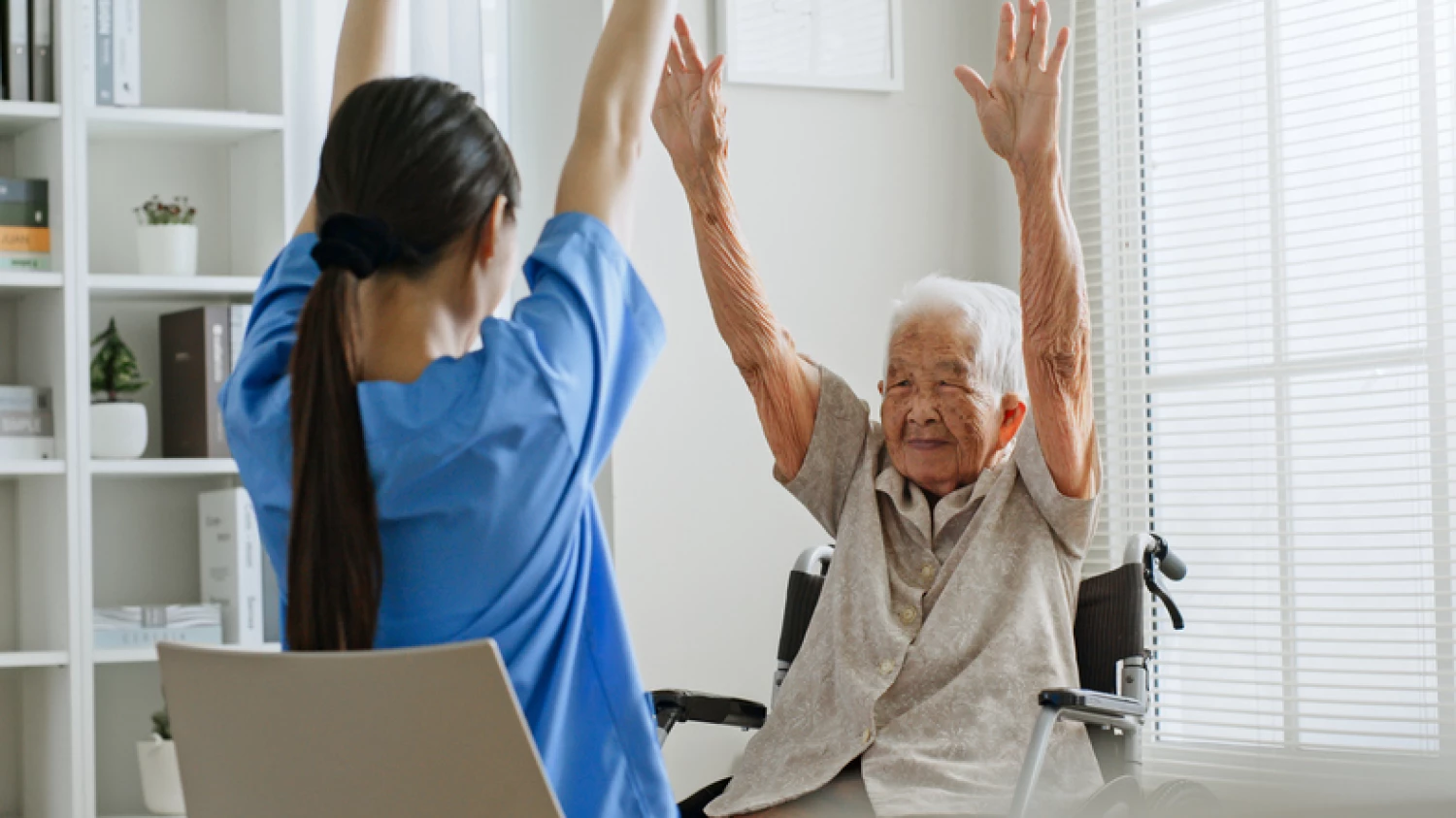 Occupational therapist assisting elderly woman with exercises, showcasing occupational therapy and in-home care services.