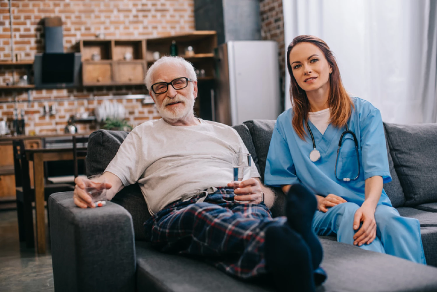 Private in-home care nurse assisting an elderly man at home, demonstrating support for independent living.