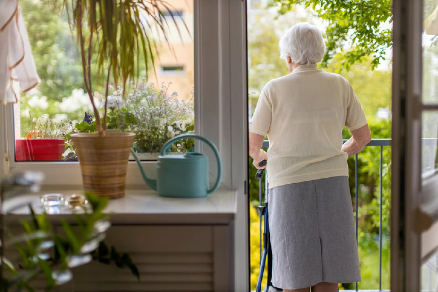 enior woman using a walker on her balcony, maintaining independence and mobility with support from occupational therapy.