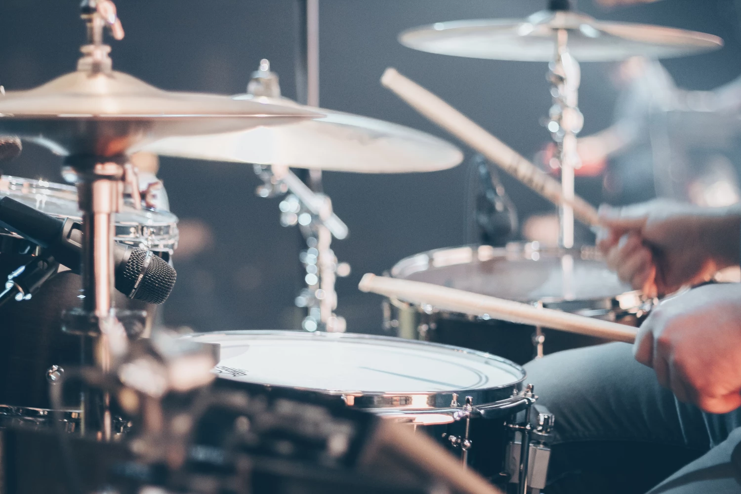 Person playing the drum as part of their Music Therapy