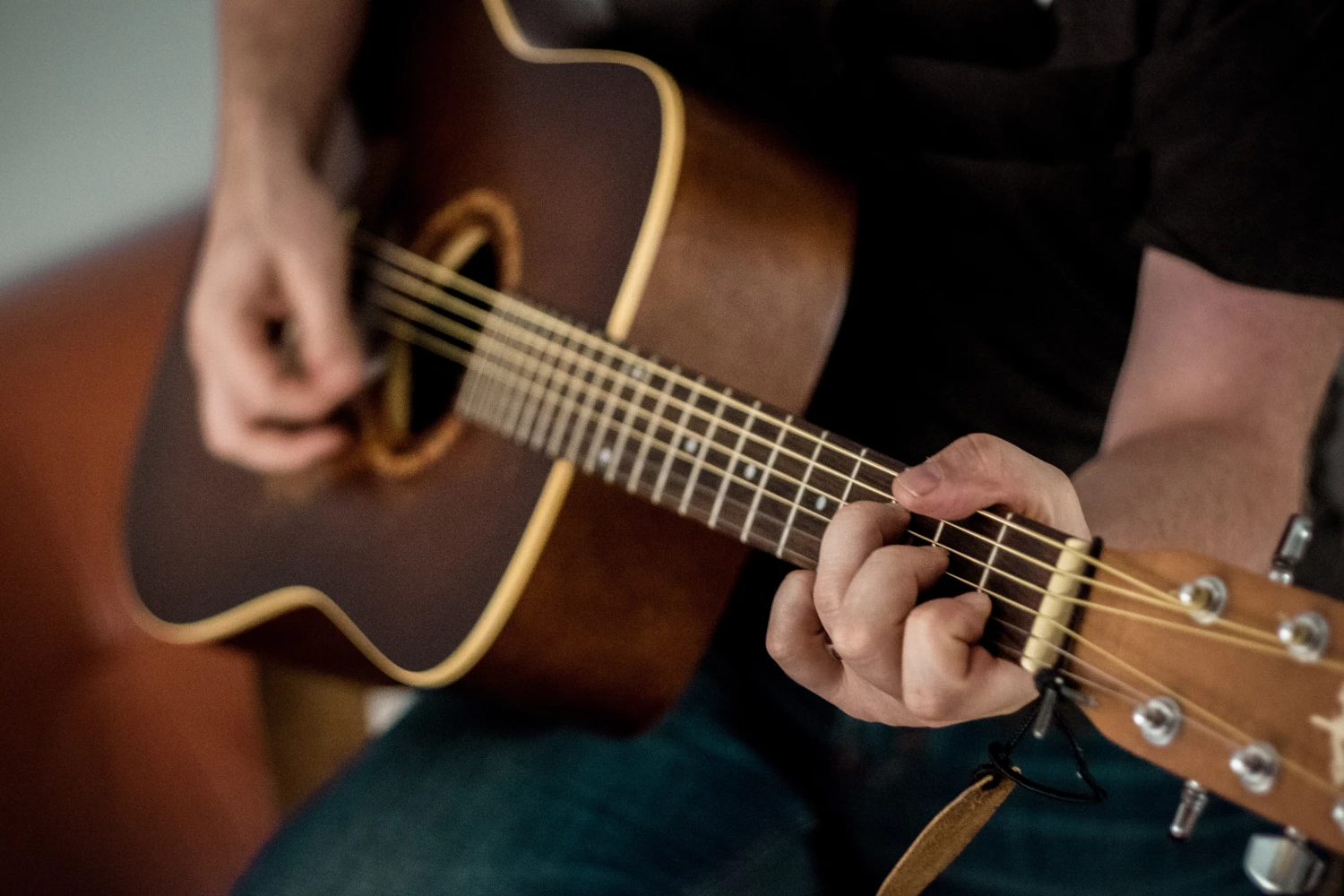 A person doing Music Therapy with guitar