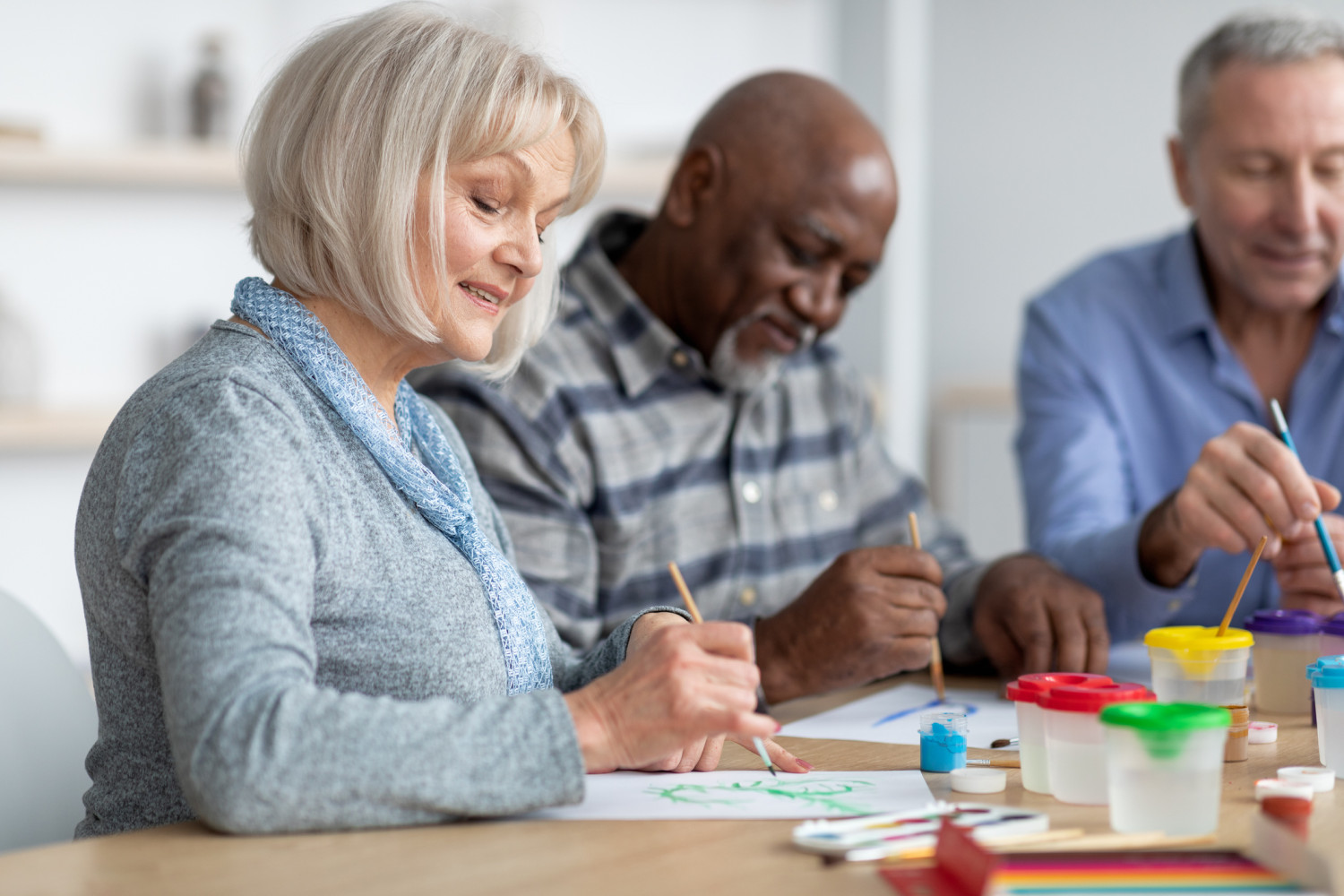 group of seniors are immersed in an art therapy class, a form of allied health service that supports emotional expression and cognitive function through creative engagement, demonstrating the holistic approach to aged care.