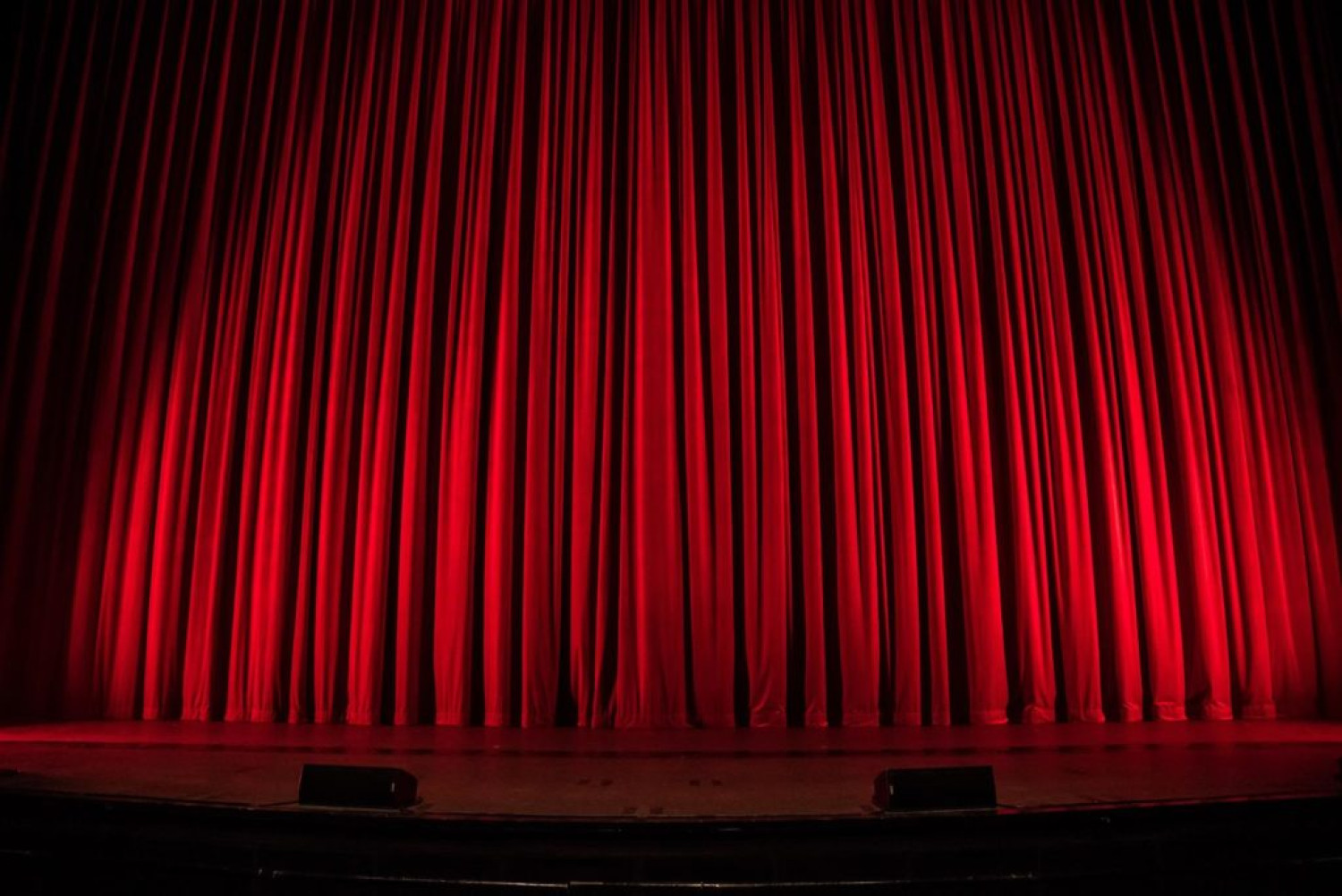 Closed red theatre curtains - Watch theatre from home - Home entertainment guide.