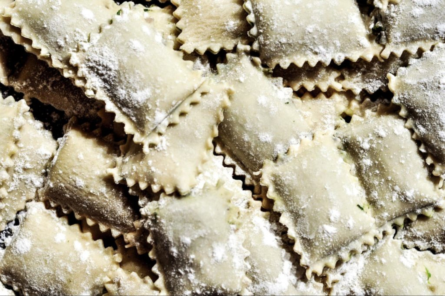 Freshly made ravioli pasta dusted with flour during pasta making - Online pasta making classes