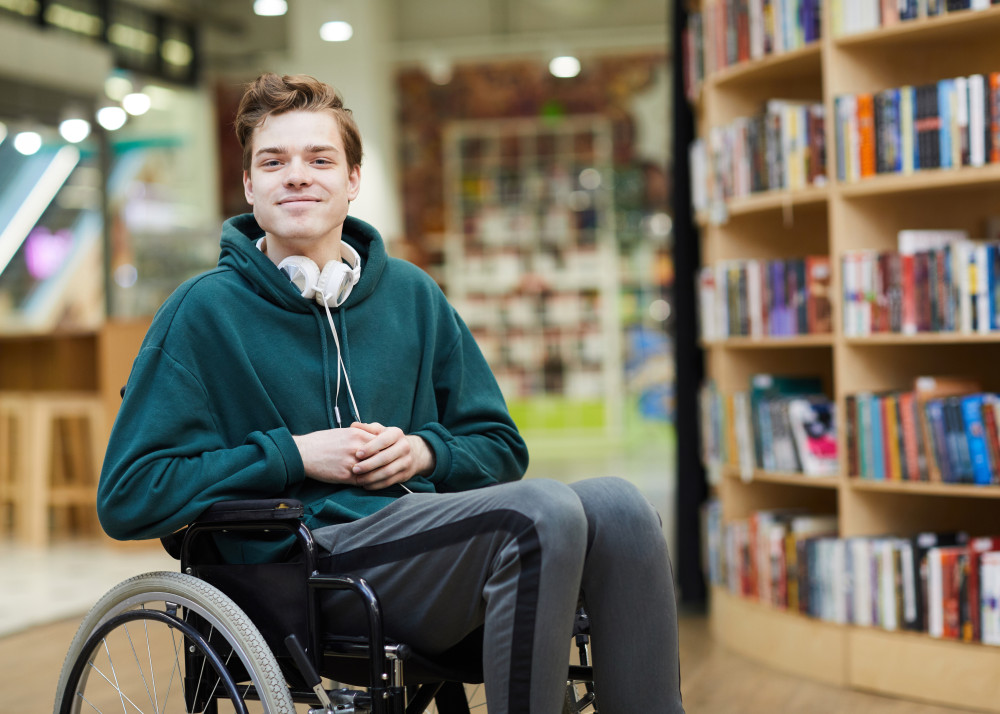 A Student With A Disability in wheelchair in a library.