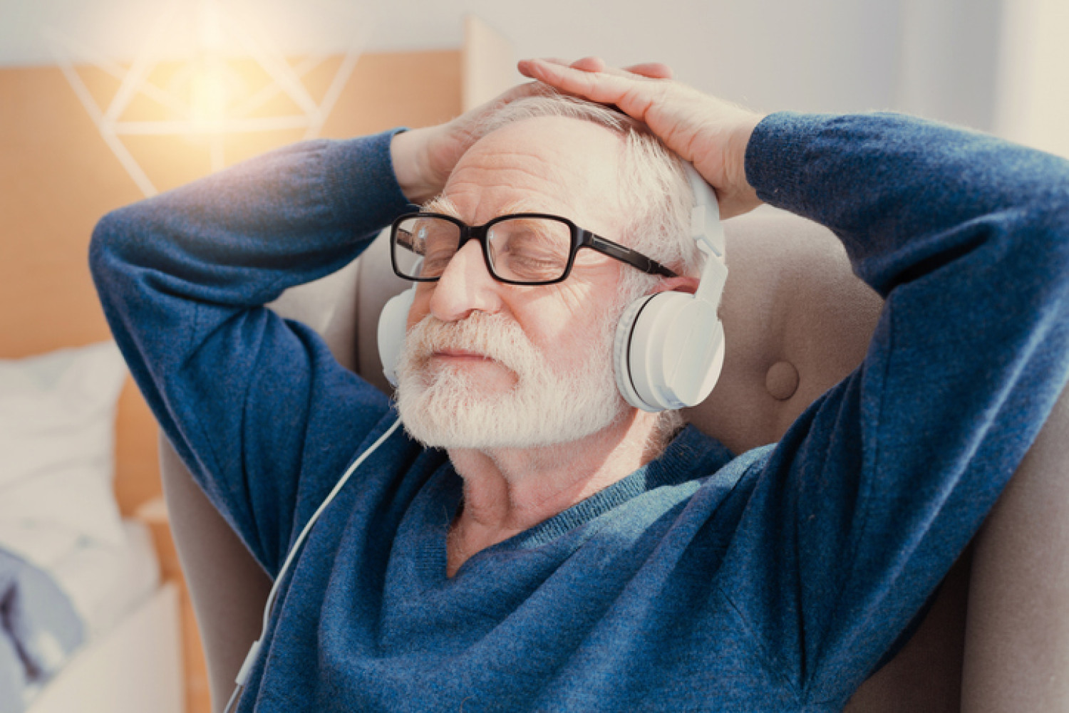 Elderly man relaxes with headphones, enjoying music therapy for dementia.