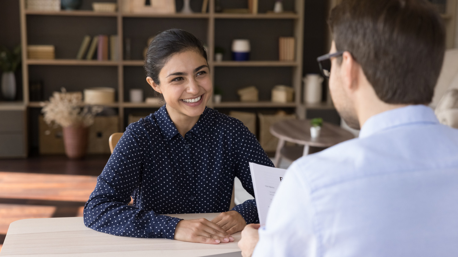 A positive job interview in progress with a potential support worker candidate in Australia, signifying the importance of interpersonal skills in the role.