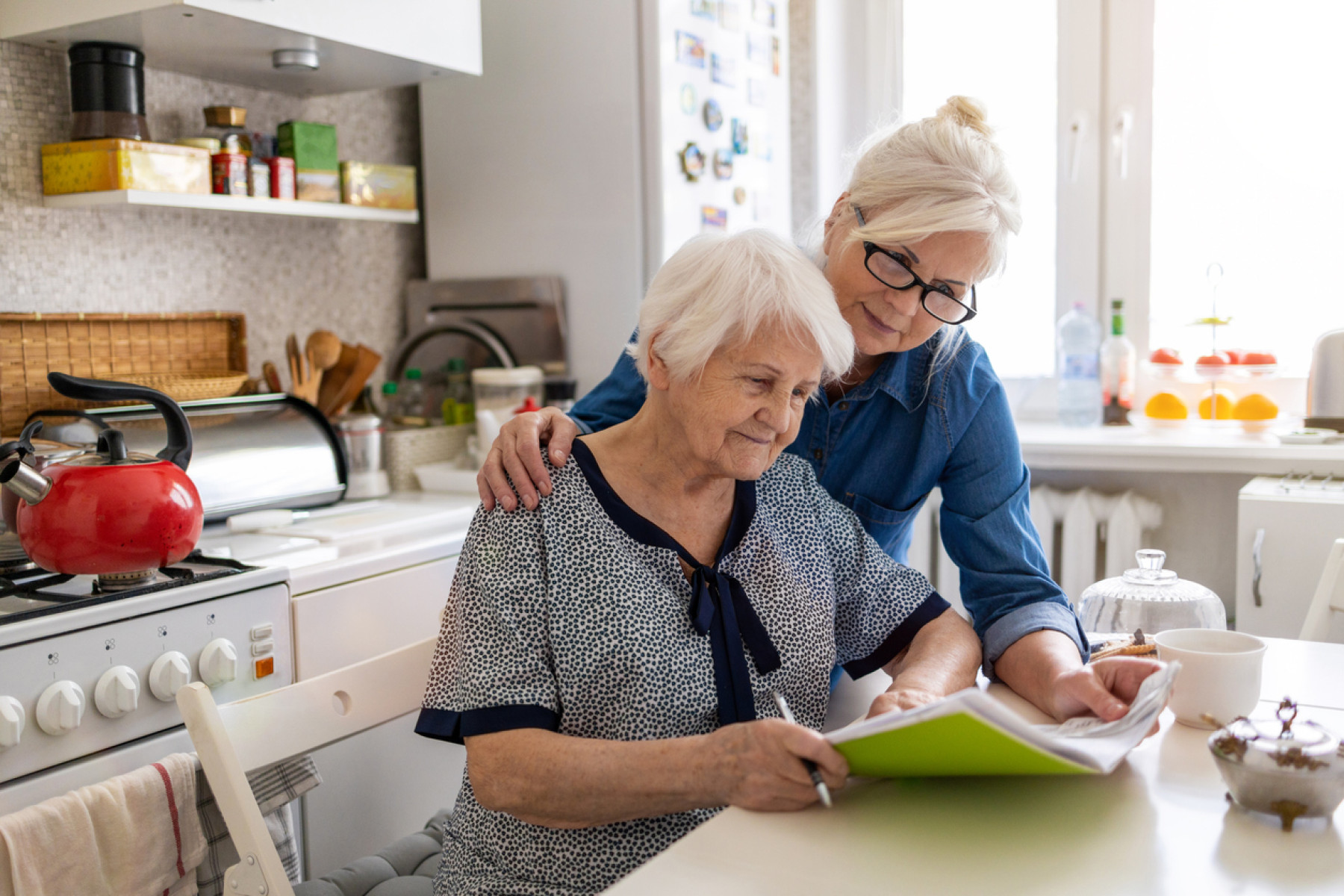 Two women applying for an home care package in their kitchen