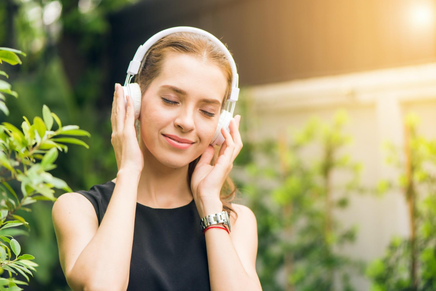 Woman smiling enjoying the Benefits of Music Therapy